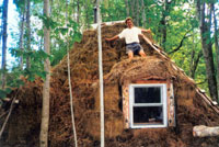 Chris stands atop the completed gamme. The straw provides a thick layer of insulation that will keep the lodge warm, even in the snow.